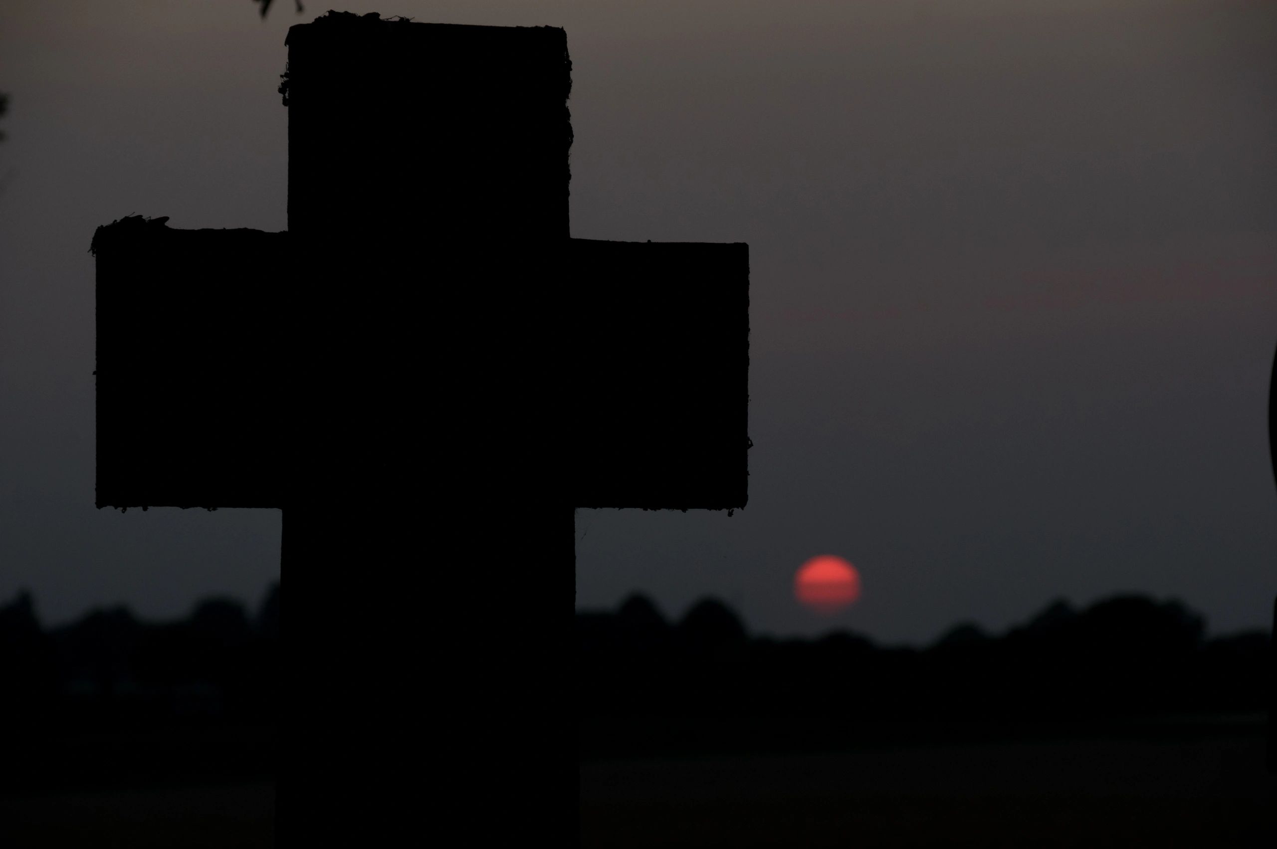 Cross silhouette in warm light (symbolic, no people)