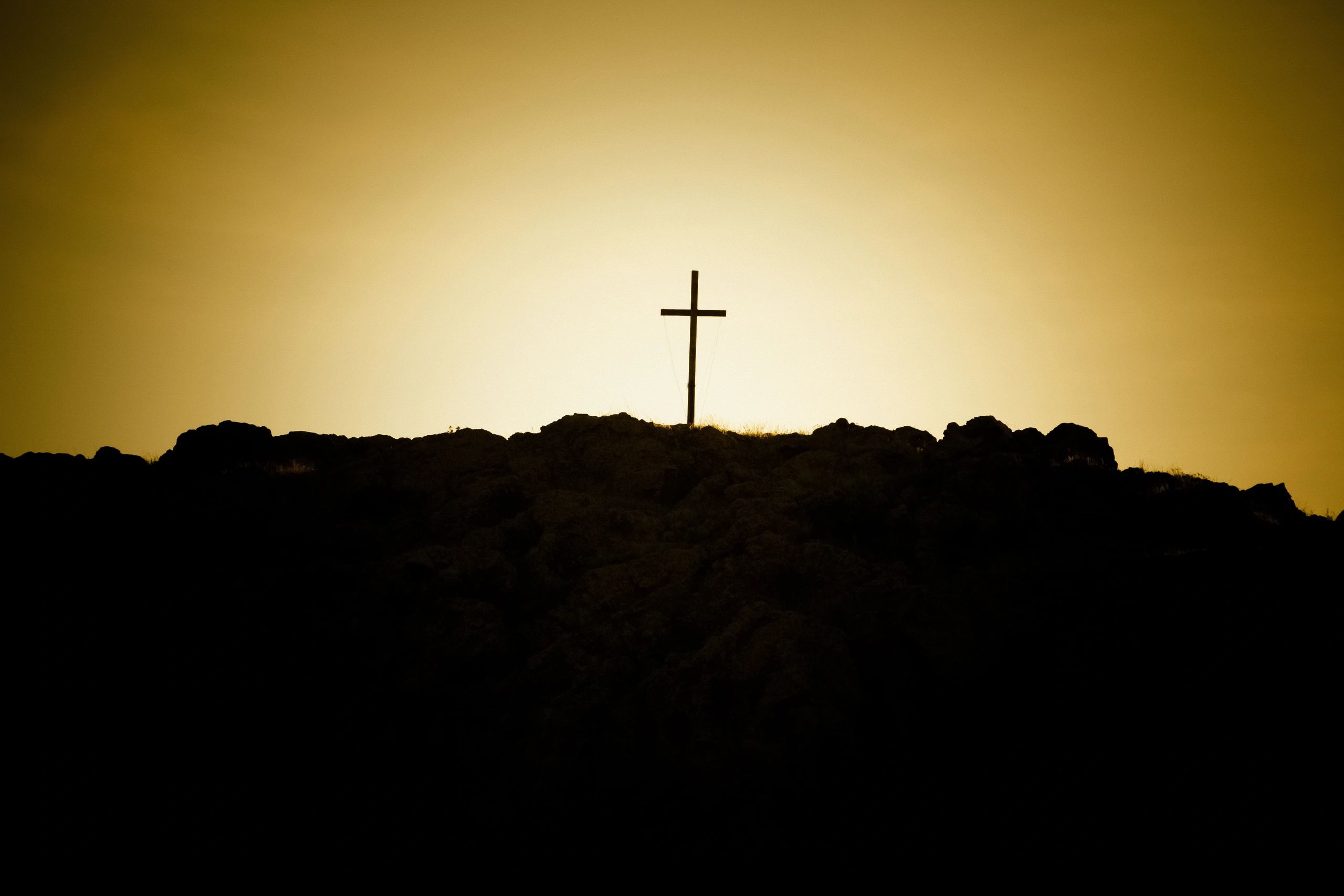 Cross on a hill in warm light (symbolic)